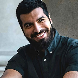 headshot of Hamza Abou Ammo smiling while looking off camera