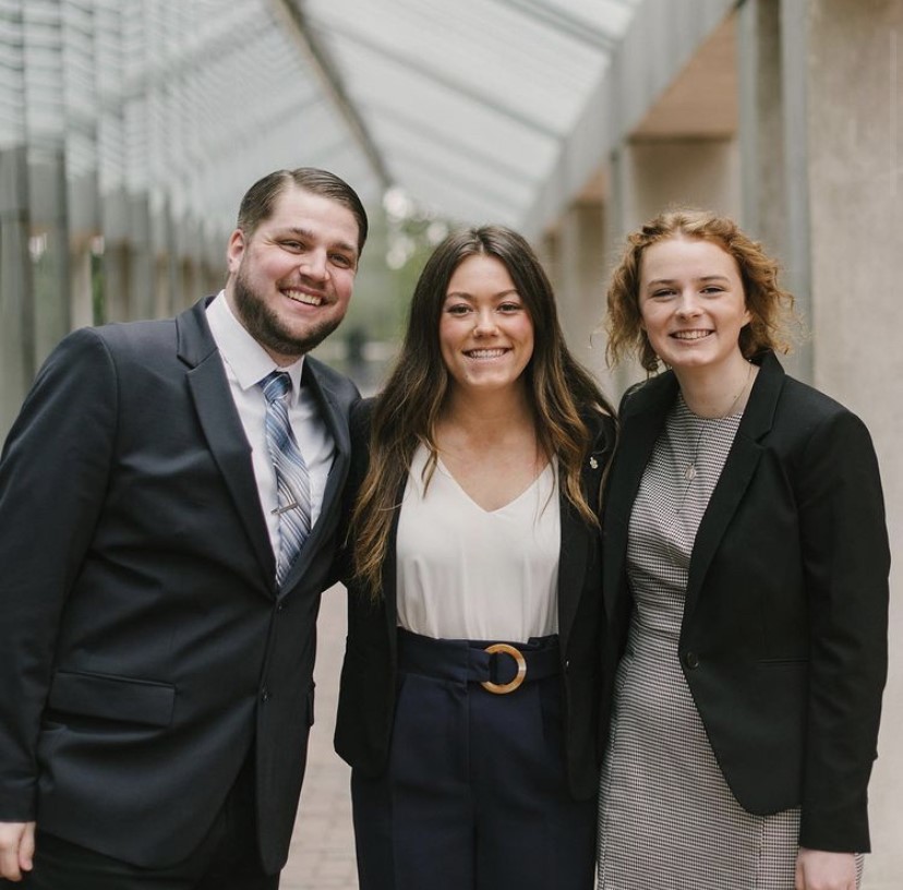 Three WWU students in professional attire pose for a photo