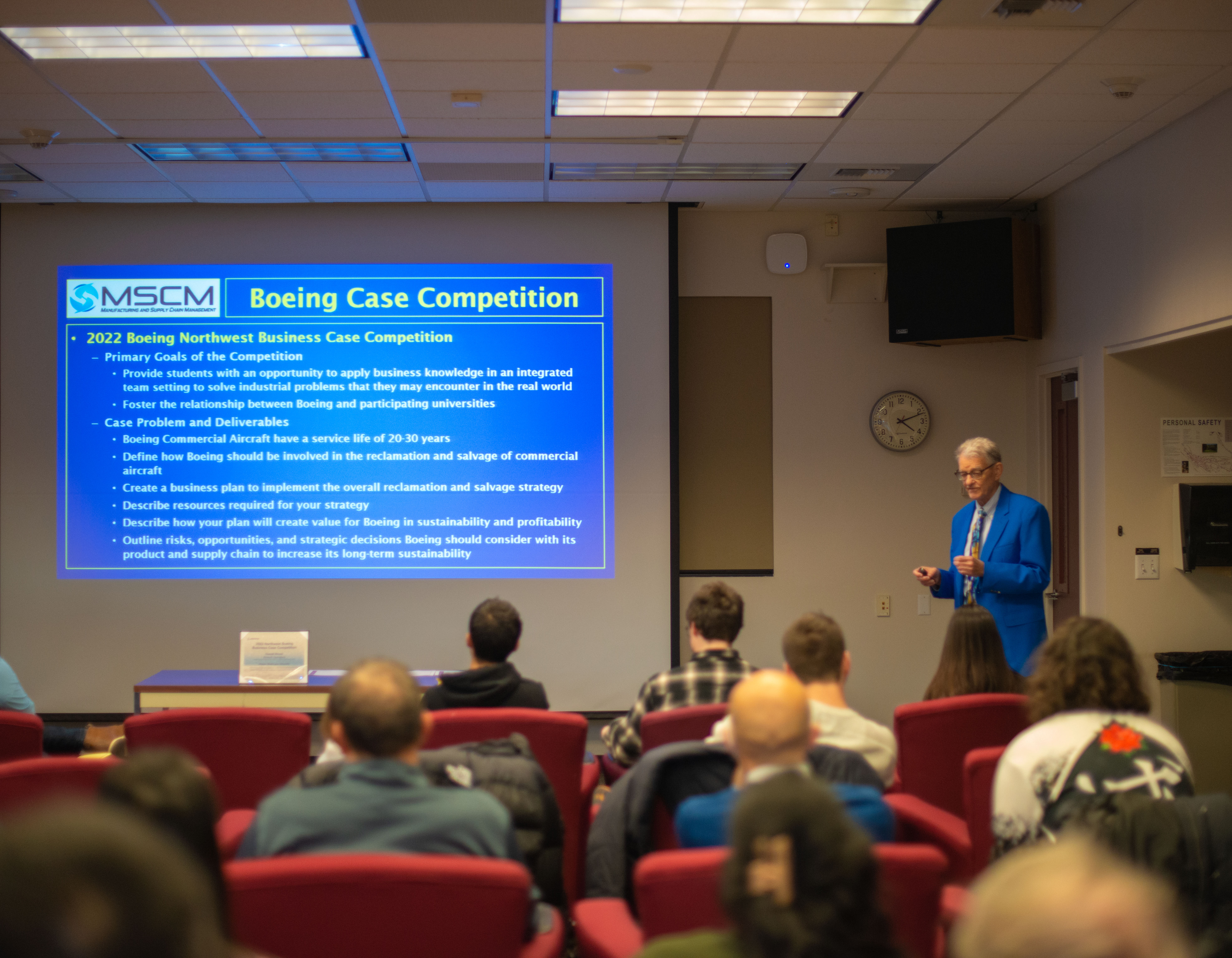 Peter Haug, the MSCM Program Director, presenting the Boeing Case Competition WWU winners