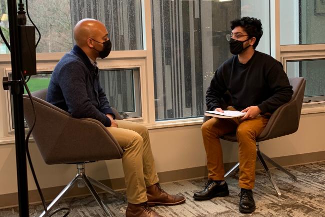 Chris Witherspoon interviews Arnav SenGupta at a table.