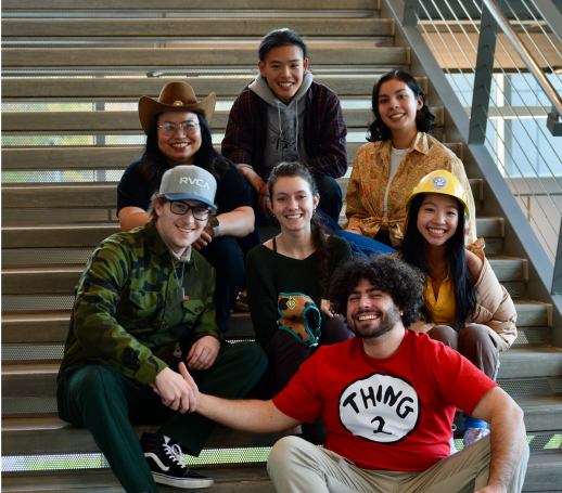 Photo of the new newsletter team on a stairwell, wearing Halloween costumes. 