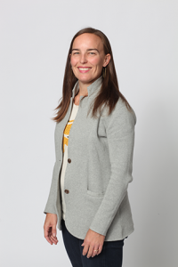 Kati Johnson in yellow blouse and gray blazer