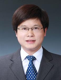 Dr. Li Xia in a gray business suit and blue dotted tie